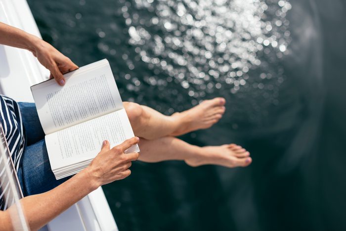 woman sitting on boat reading