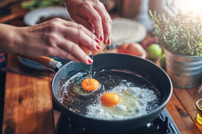 frying two eggs in a pan