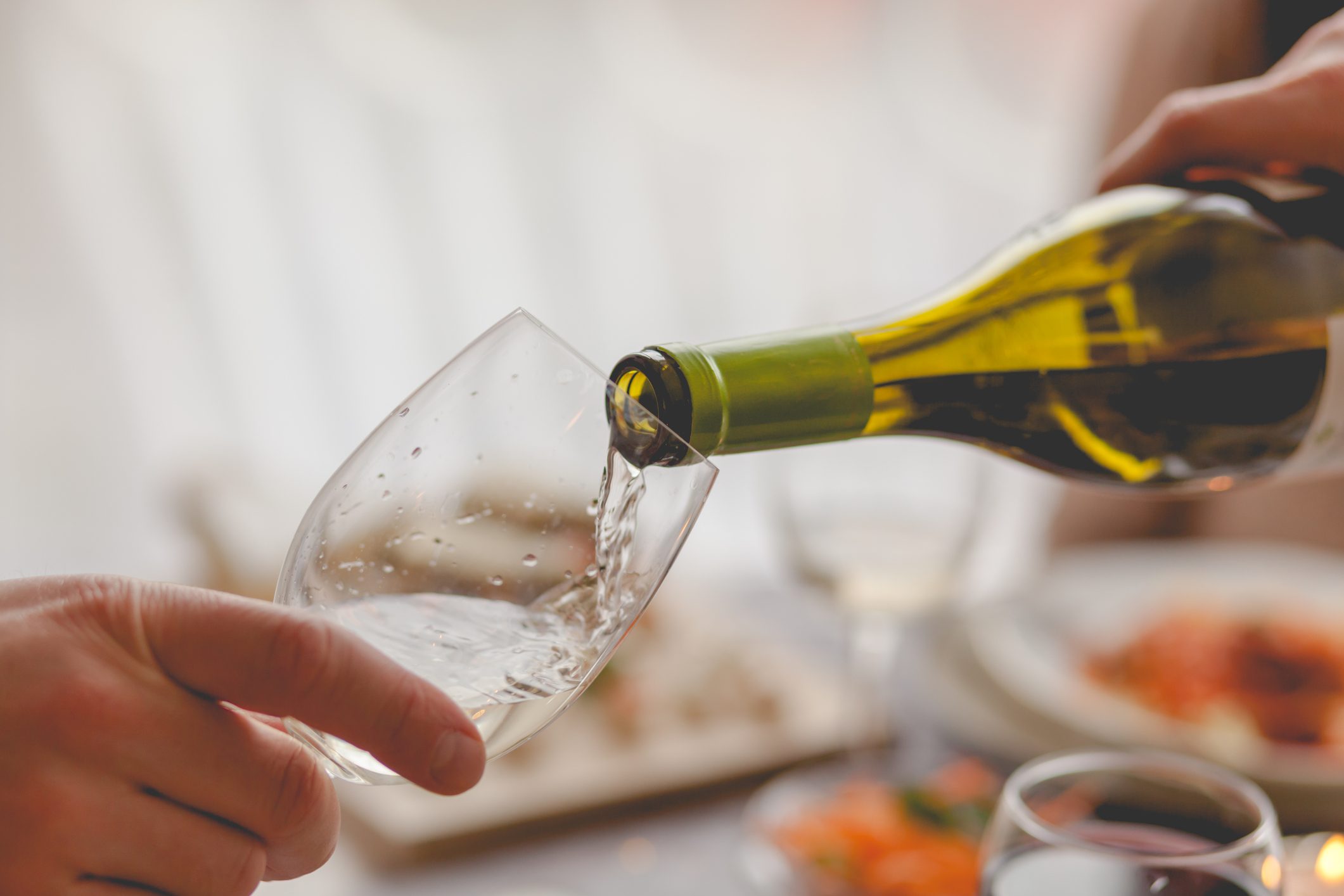 close up of pouring a glass of white wine