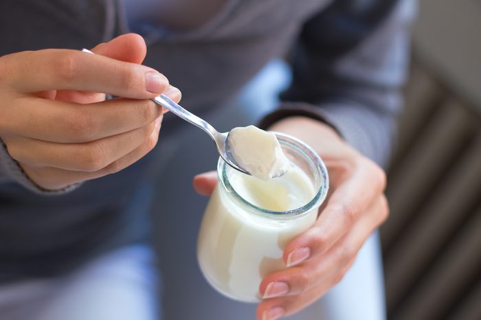 close up of person eating yogurt