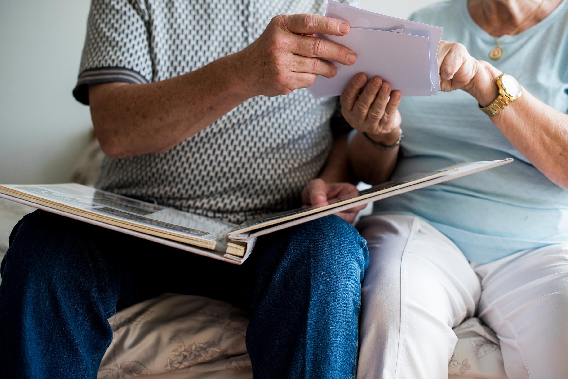 Senior couple looking at family photo album