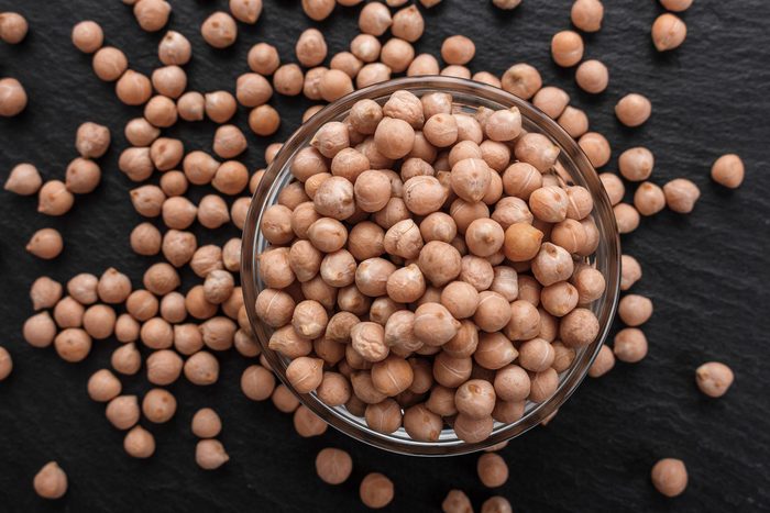 uncooked chickpeas on a dark stone background