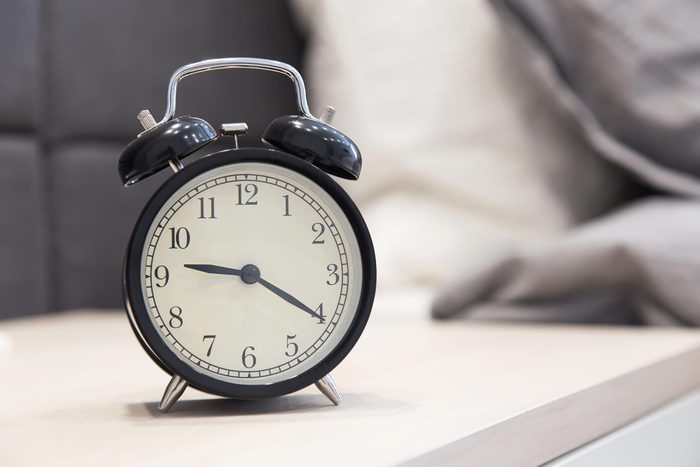alarm clock on the nightstand beside the bed. Interior bedroom