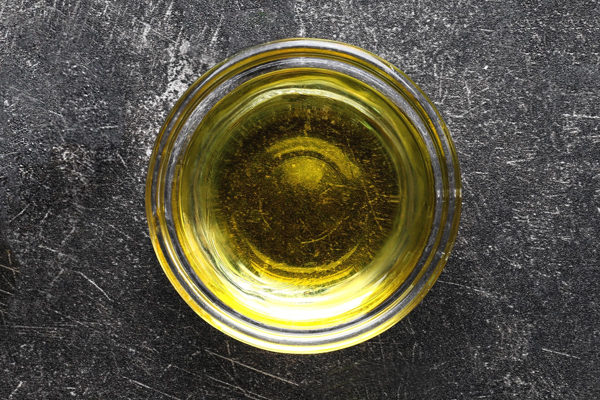 Glass bowl of light olive oil
