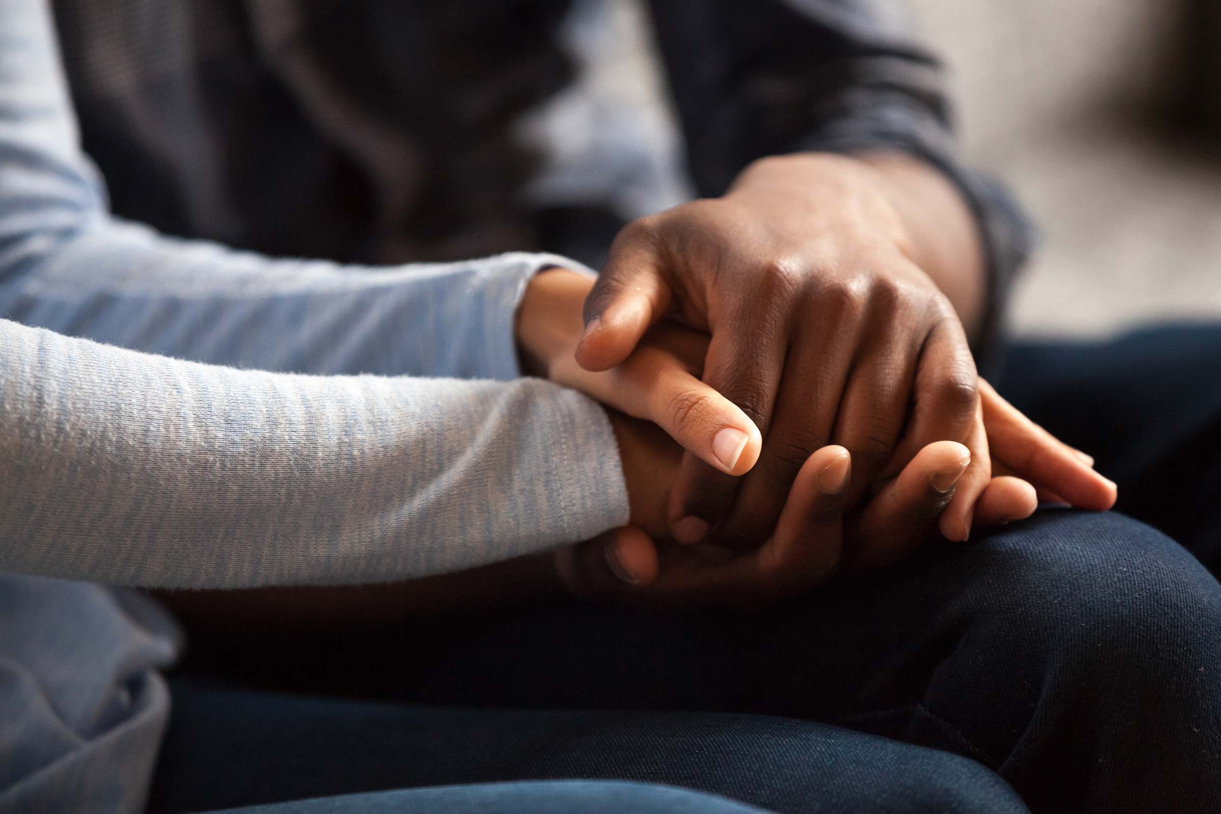 close up of two people holding hands