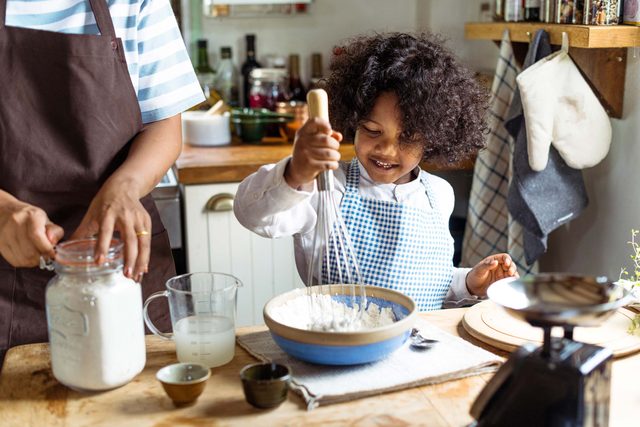 little kid making mess in kitchen