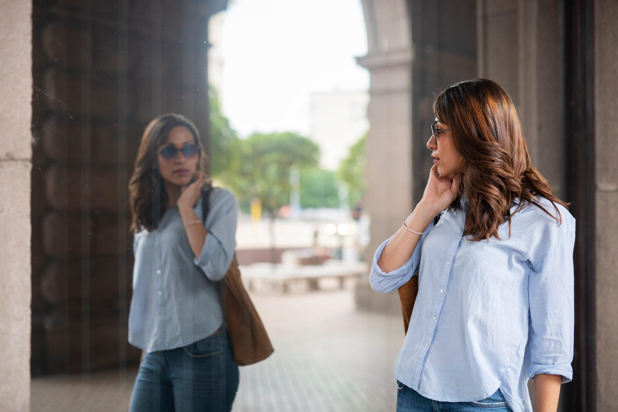 woman looking at her own reflection