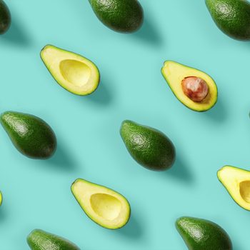 Avocado pattern on blue background. Pop art design, creative summer food concept. Green avocadoes, minimal flat lay style. Top view. Banner.