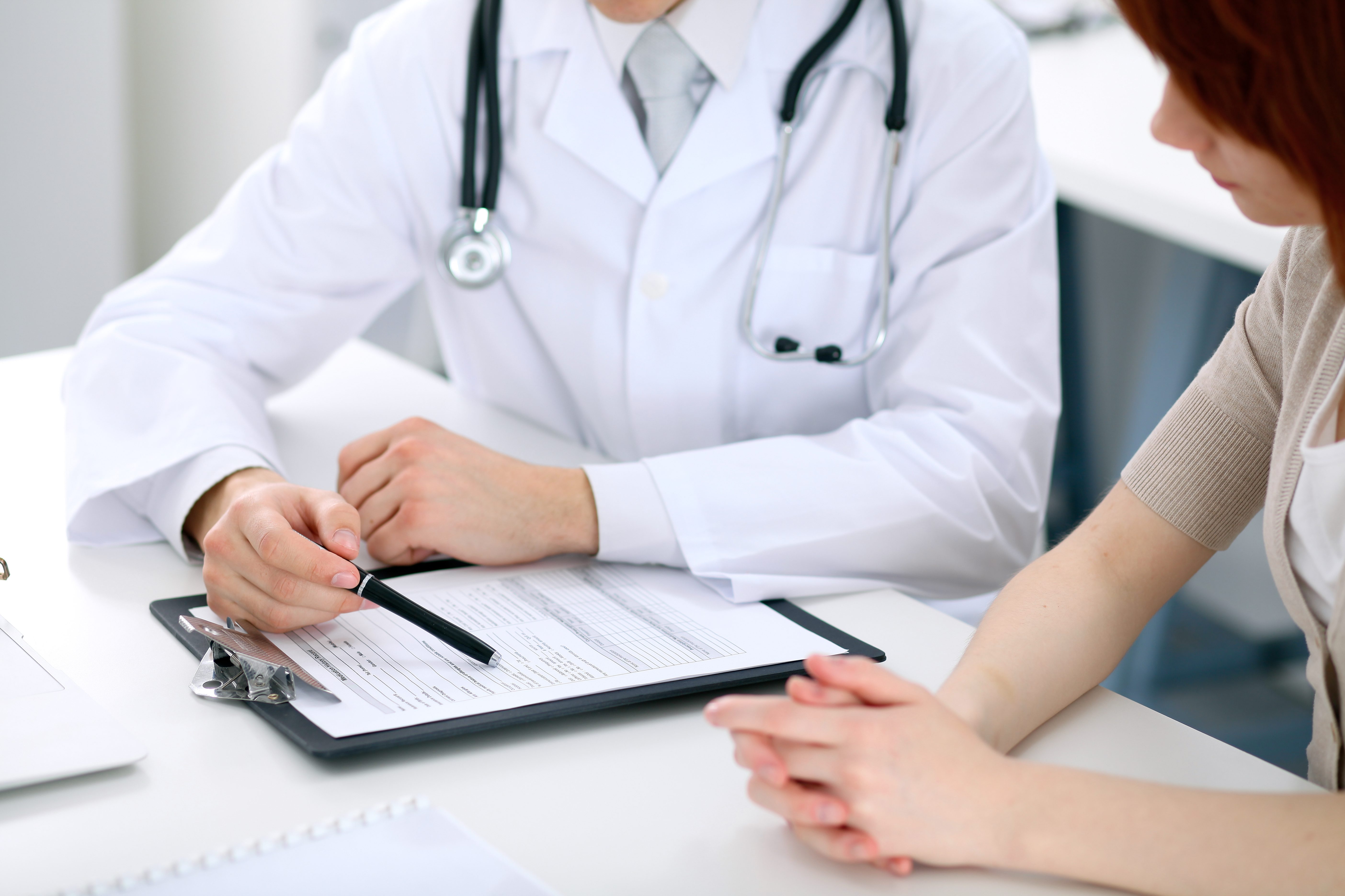 Doctor and patient are discussing something, just hands at the table