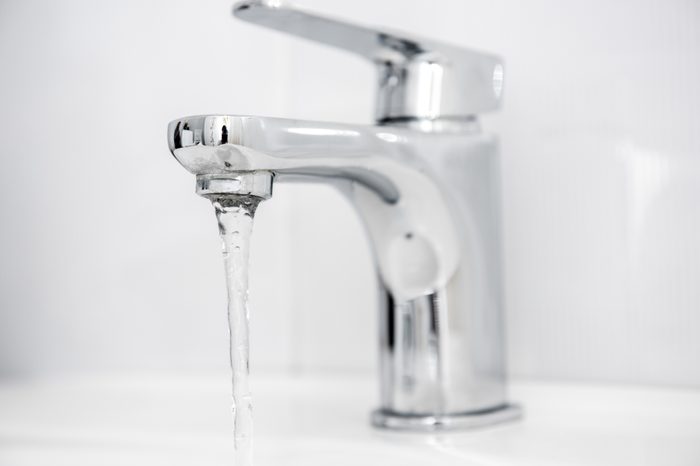 Water tap flowing in The bathroom