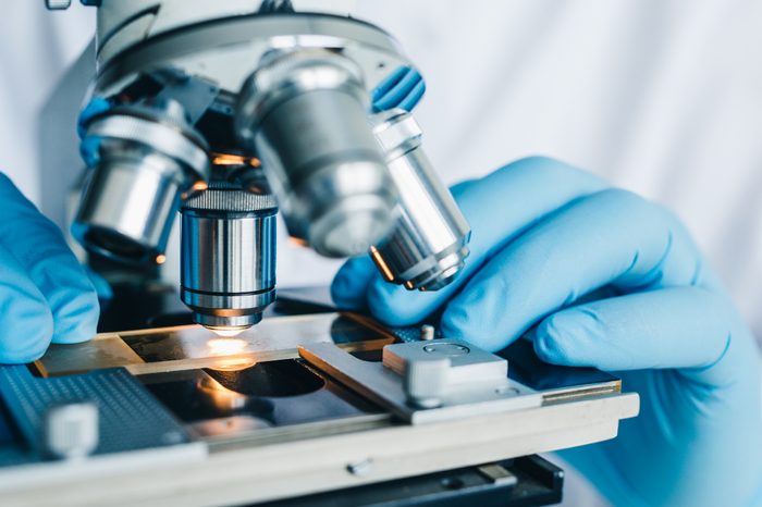 Close-up shot of microscope with metal lens at laboratory.