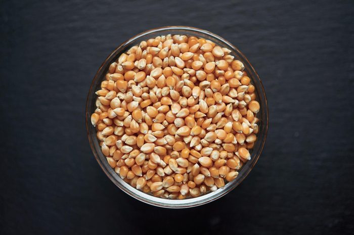 Corn kernels in a bowl on dark background