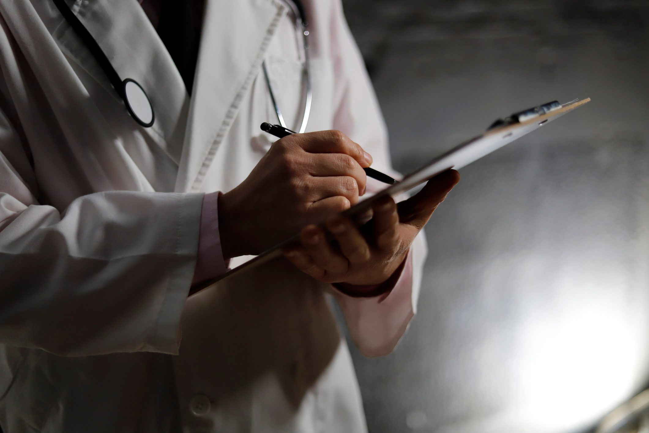 close up cropped shot of doctor holding clipboard