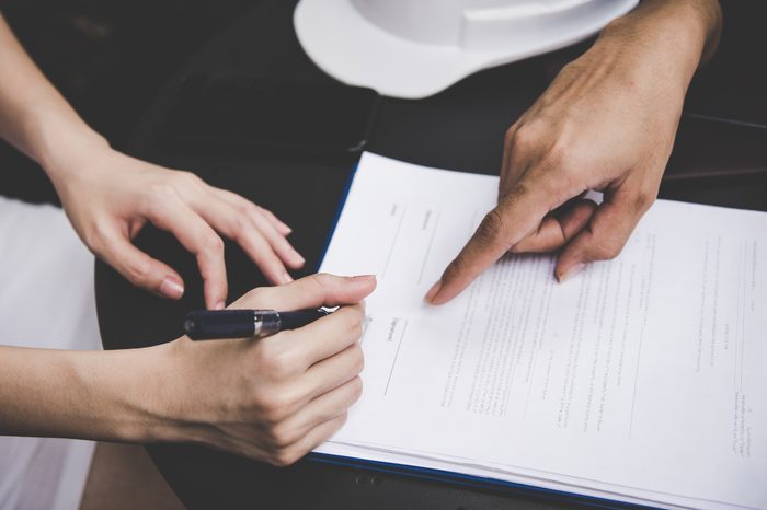 hands signing a contract