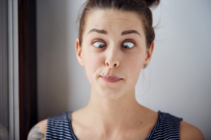 woman crossing her eyes and making a face