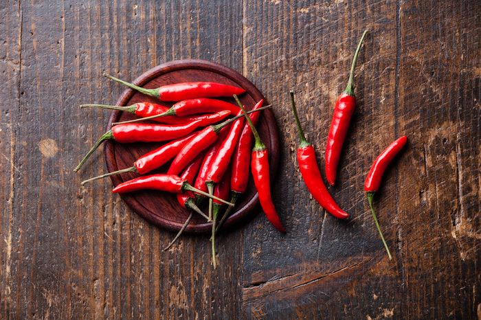 hot chili peppers on wooden background