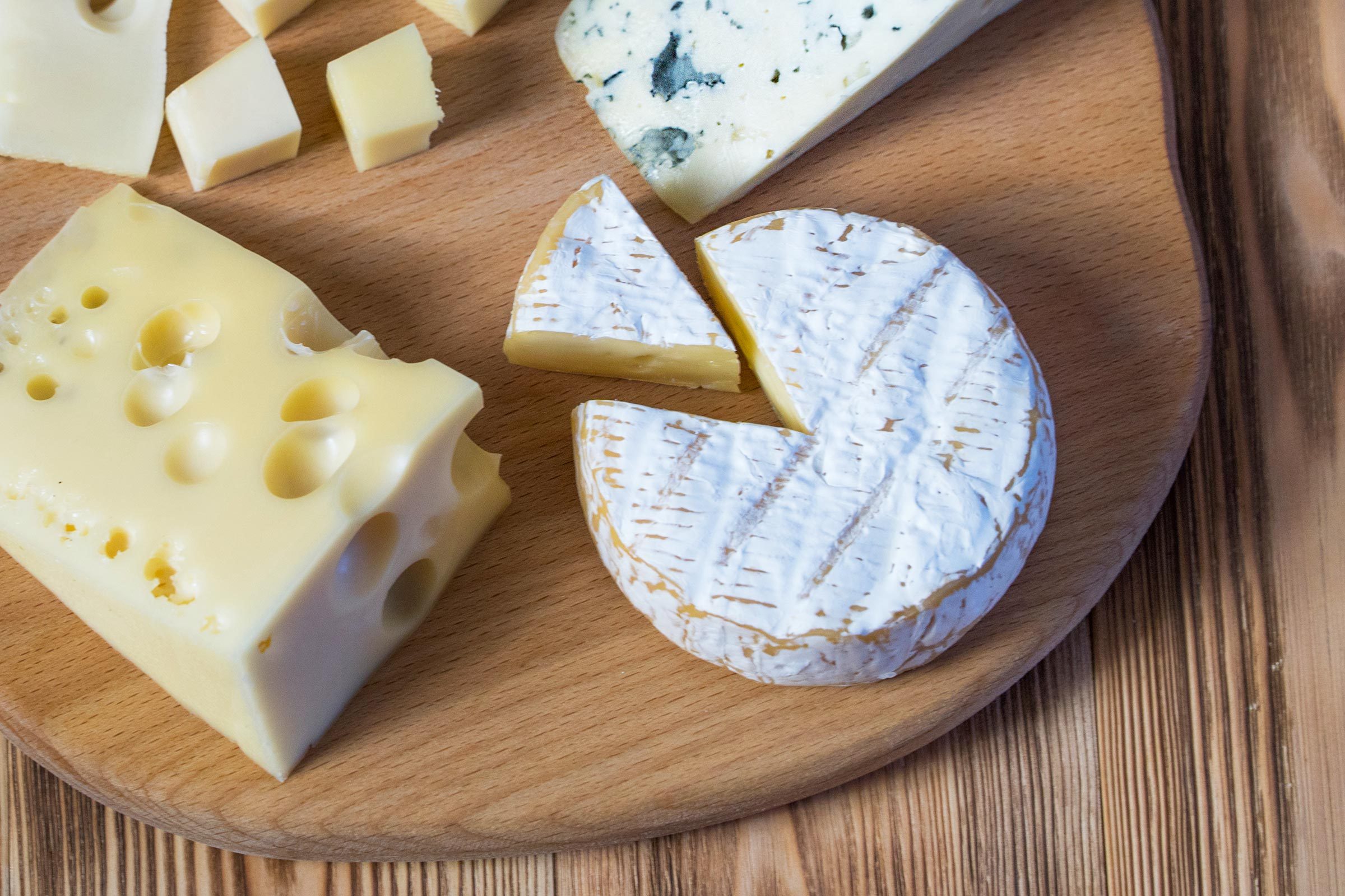 cheese plate a selection of cheeses on a wooden board