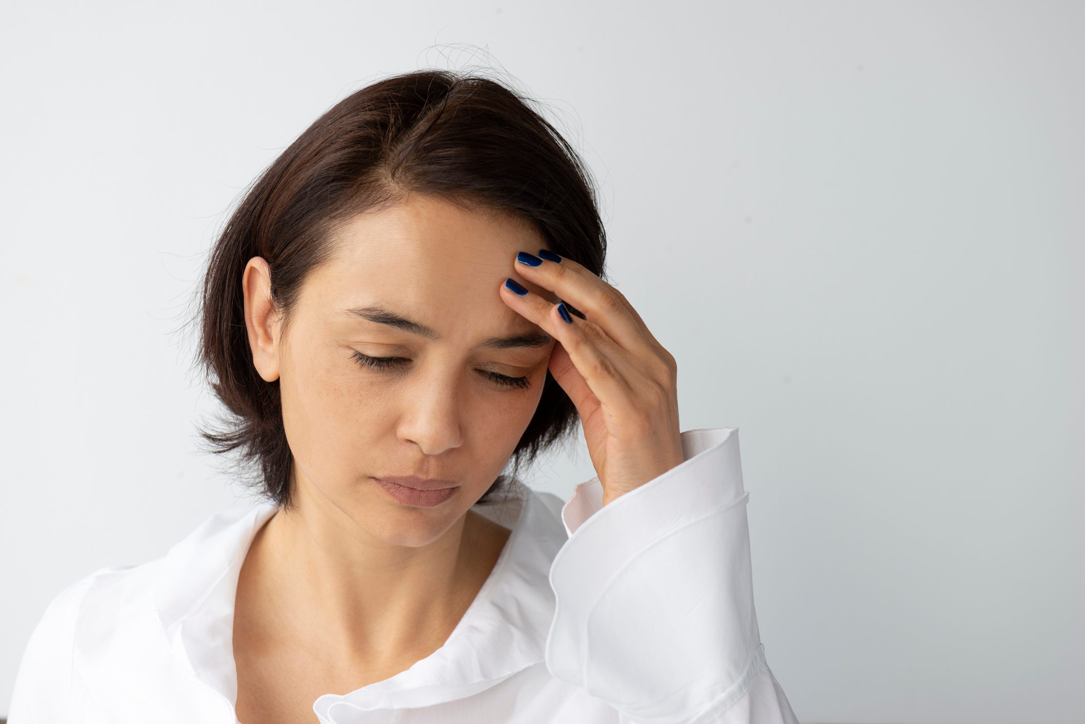 woman with hand on head