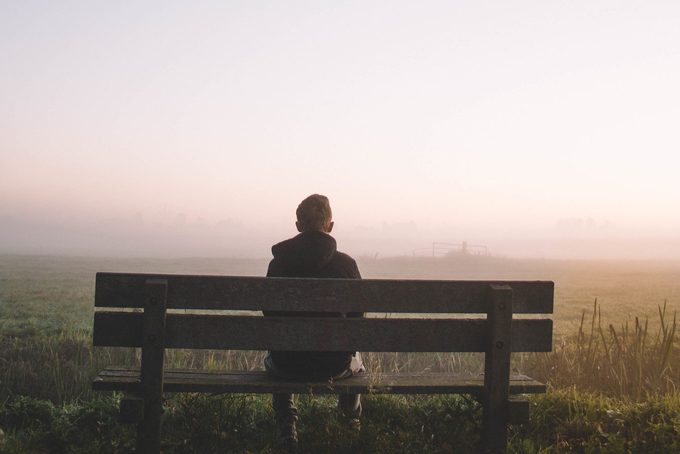 rear view of man sitting on a bench