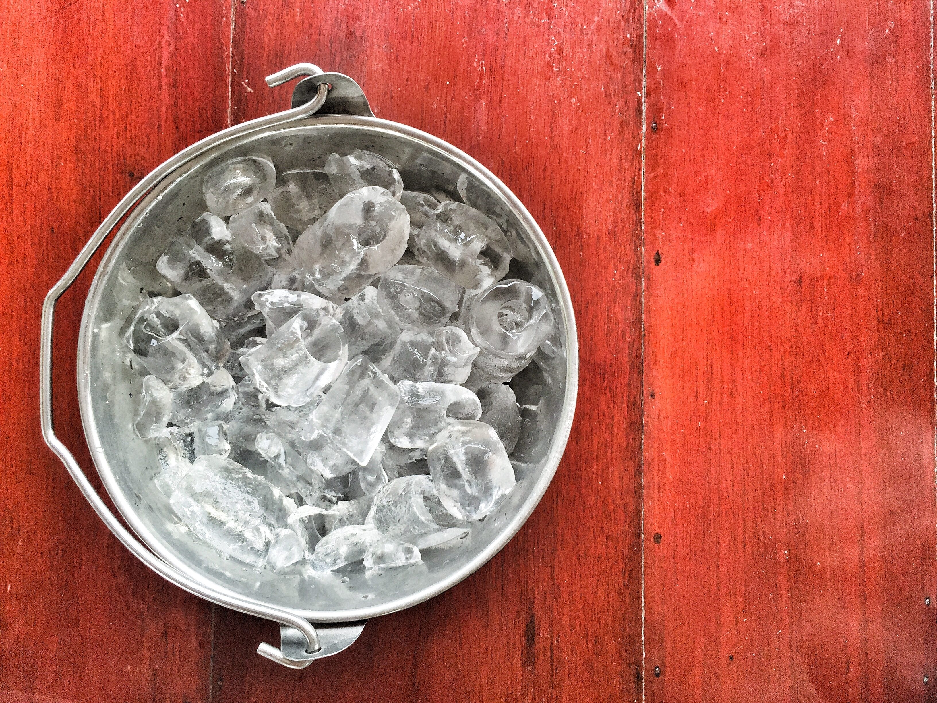 Ice cube in bucket on the wood table,with preset color.