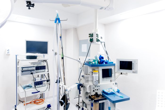 Interior of surgery room inside modern hospital, surgery table with medical devices and monitors