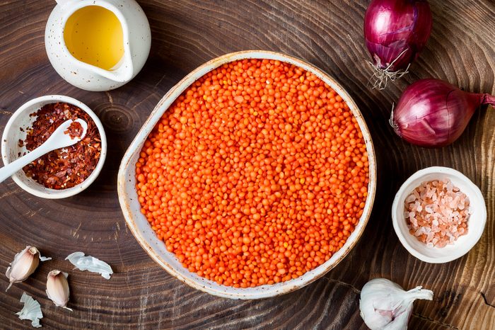 Cooking traditional red lentil Dal. Ingredients for Indian Dhal spicy curry. Top view, overhead