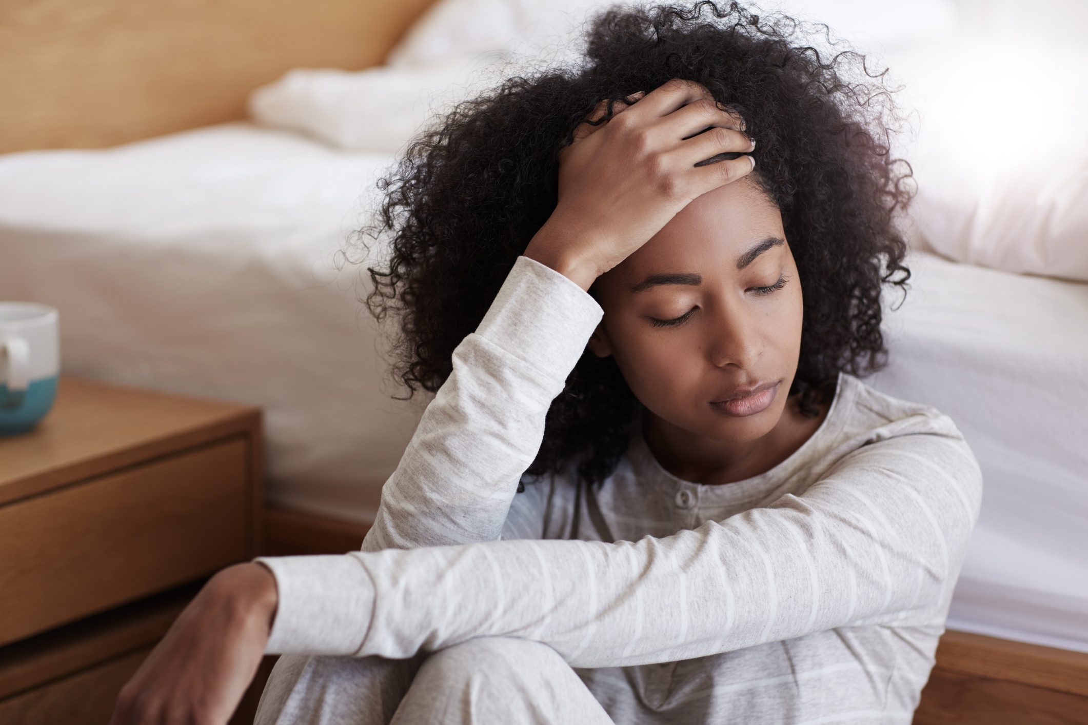 tired young woman sitting on the floor