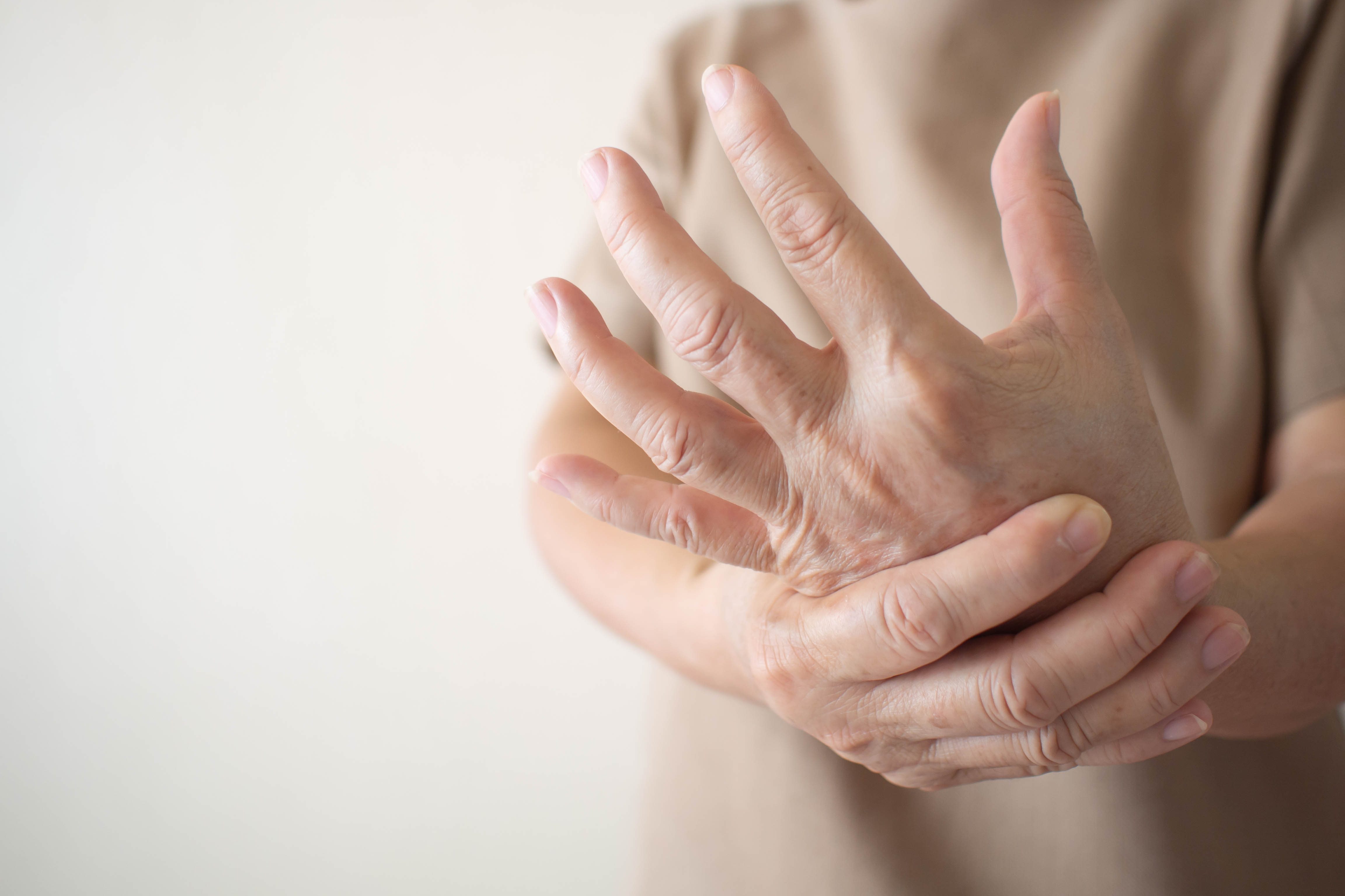 woman rubbing her hand pain