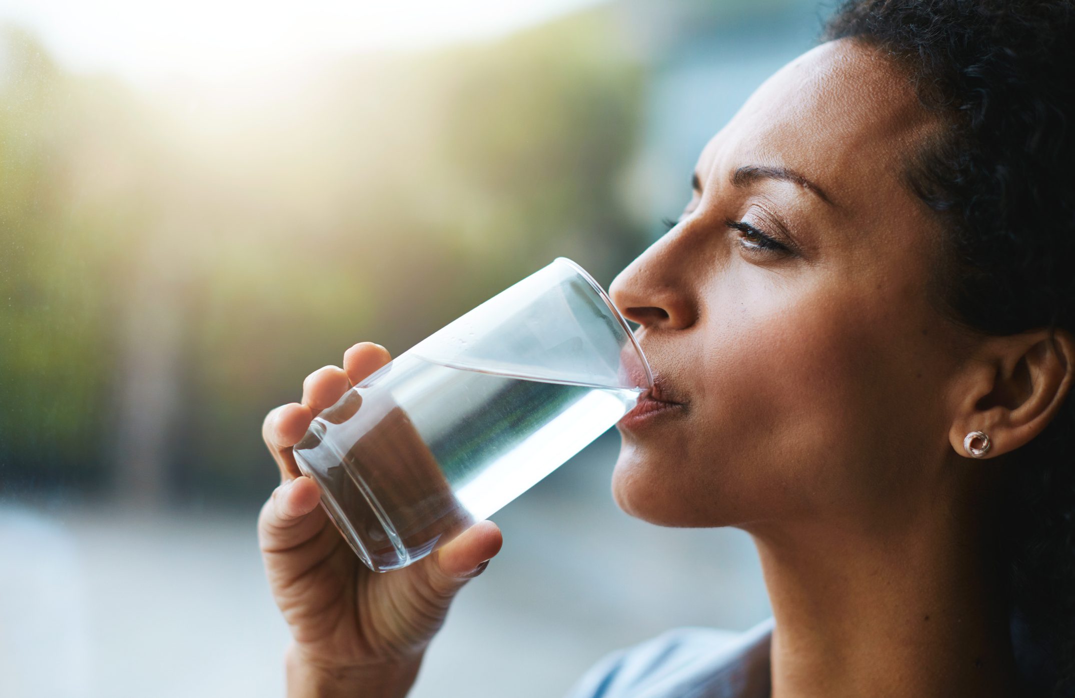 woman drinking a glass of water