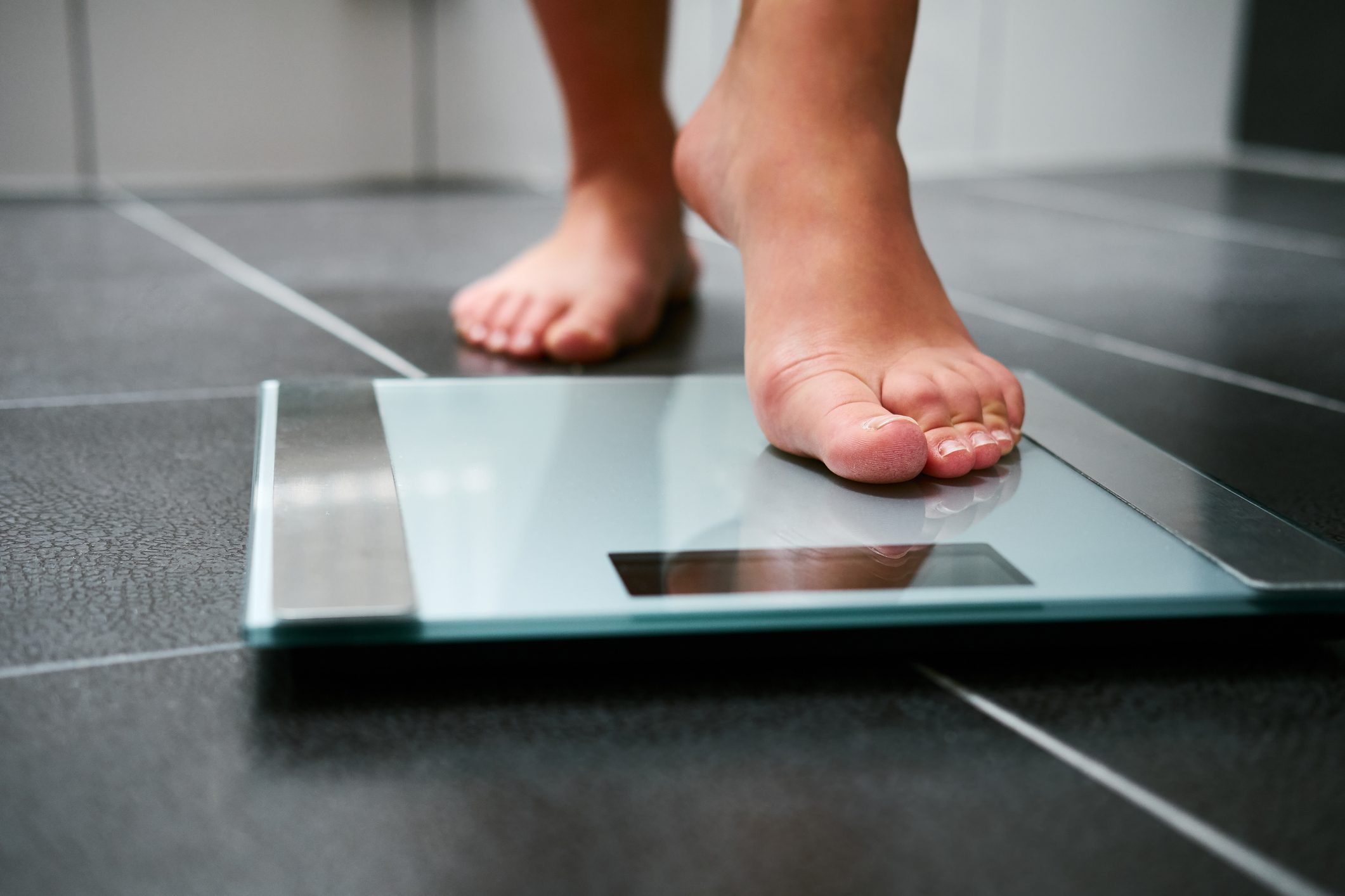 close up of feet on weight scale