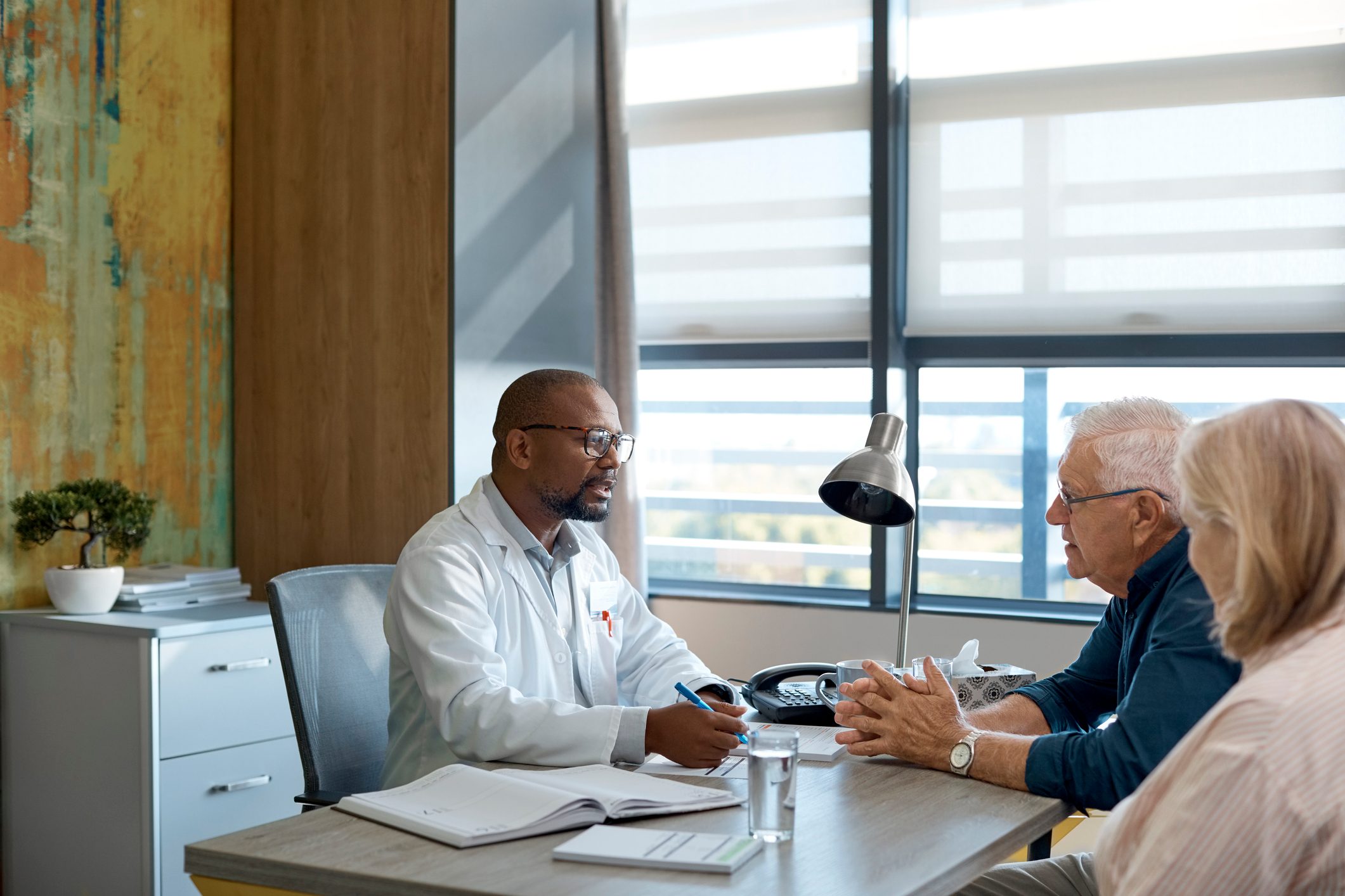 doctor meeting with patient and spouse