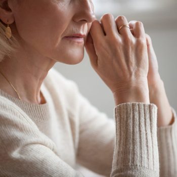 Close up view of thoughtful mature woman worried concerned about problems or disease, middle aged grey haired senior lady getting older thinking of loneliness depression grief anxiety concept