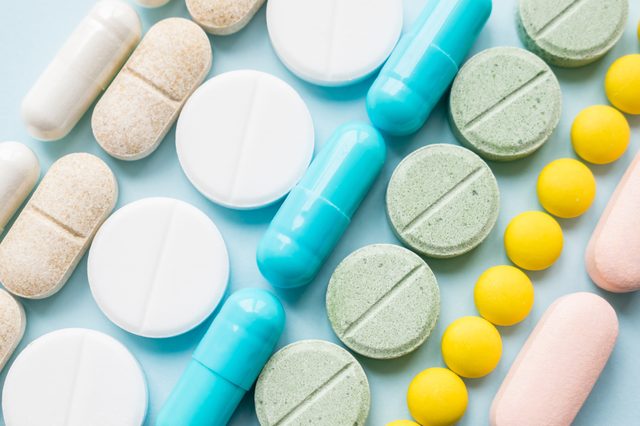 Opioid painkillers crisis and drug abuse concept. Opioid and prescription medication addiction epidemic. Different kinds of multicolored pills. Pharmaceutical medicament background