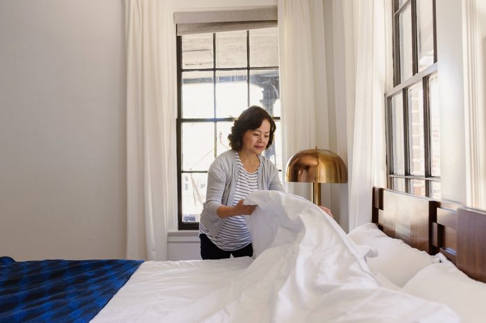 woman making her bed