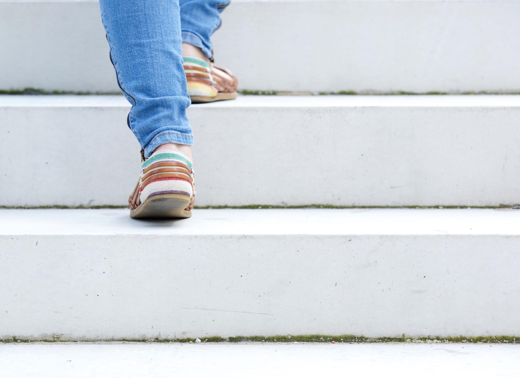 close up on woman walking up stairs