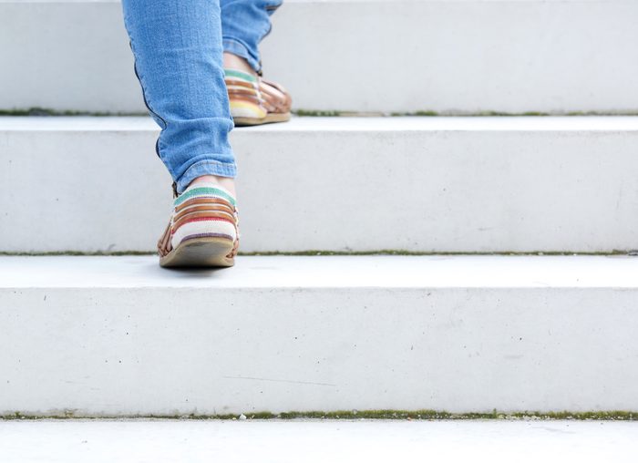 close up on woman walking up stairs
