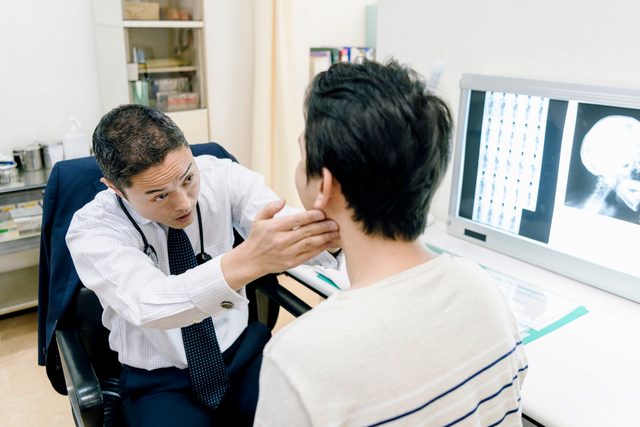 doctor examining patient's jaw