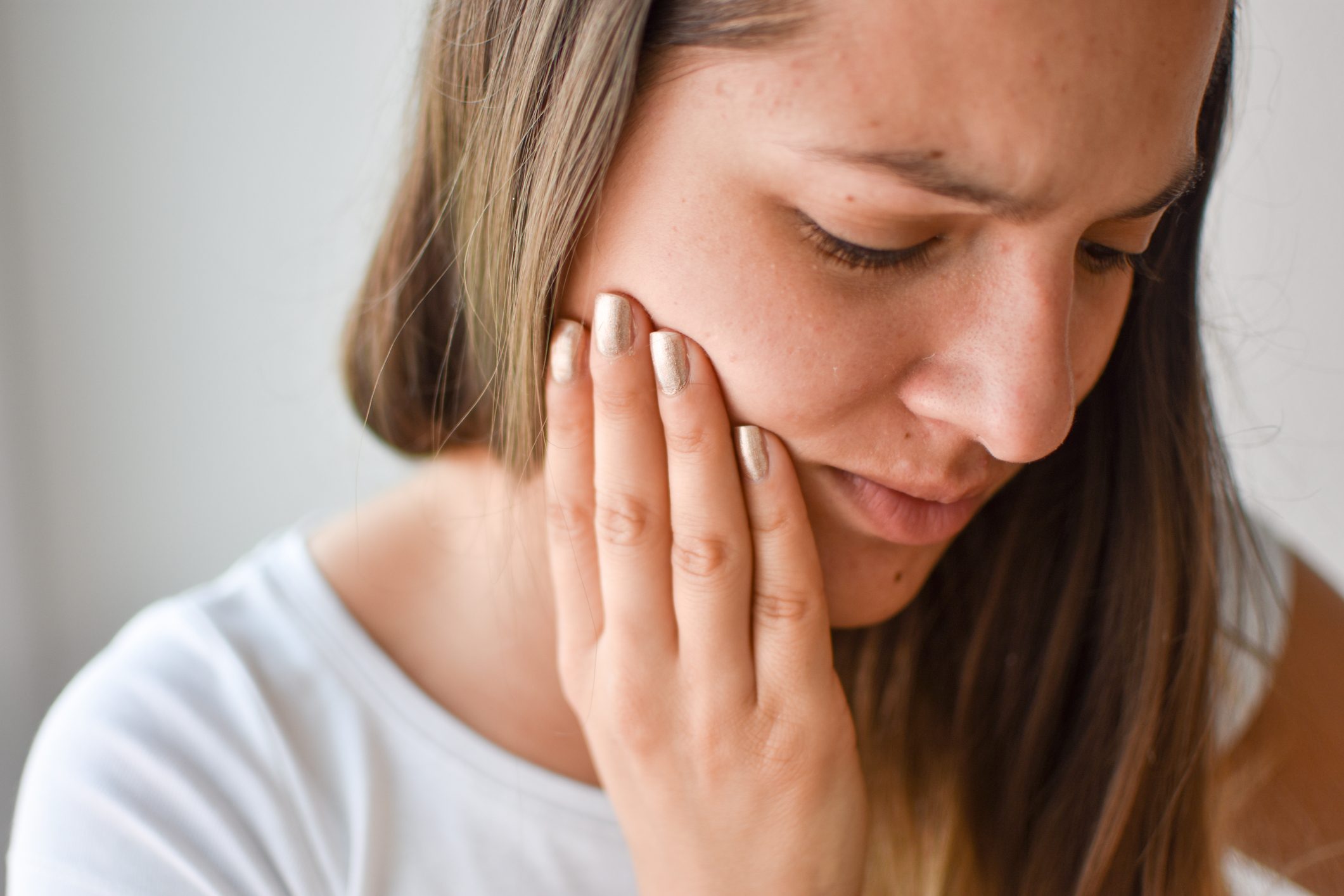 young woman suffering from jaw pain