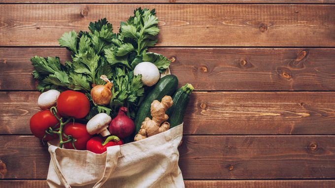 fresh produce in grocery bag overhead