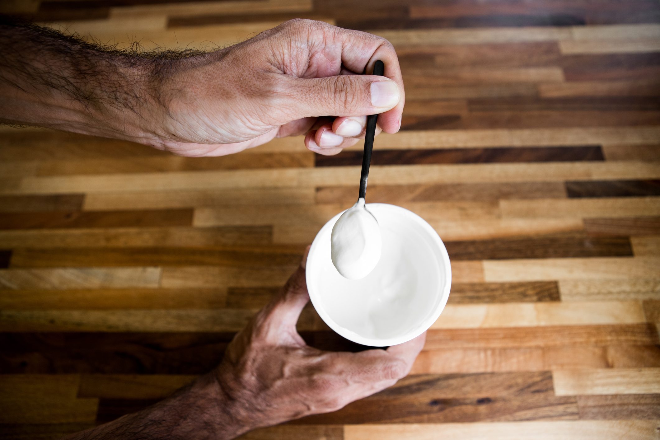 overhead shot of man eating yogurt