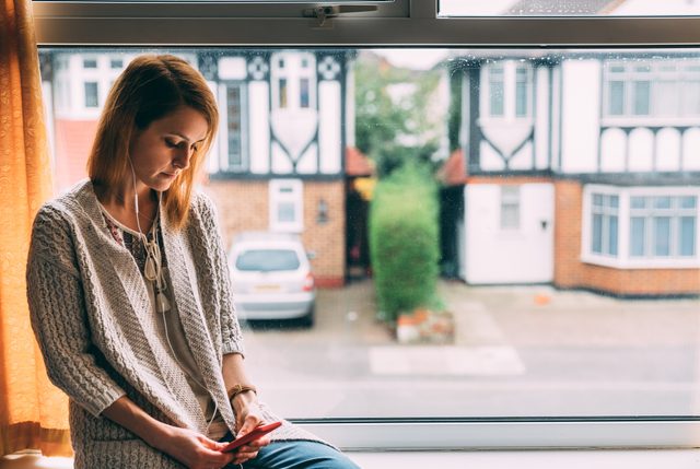 Woman staying home for safety during coronavirus pandemic is talking on video call with friend