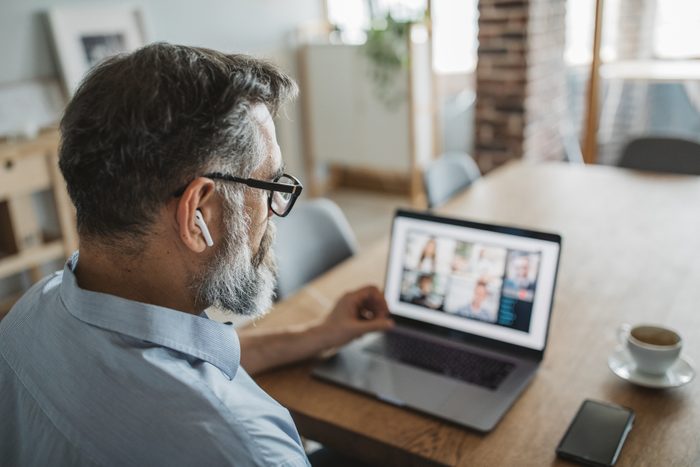 man on video conference call with coworkers working from home