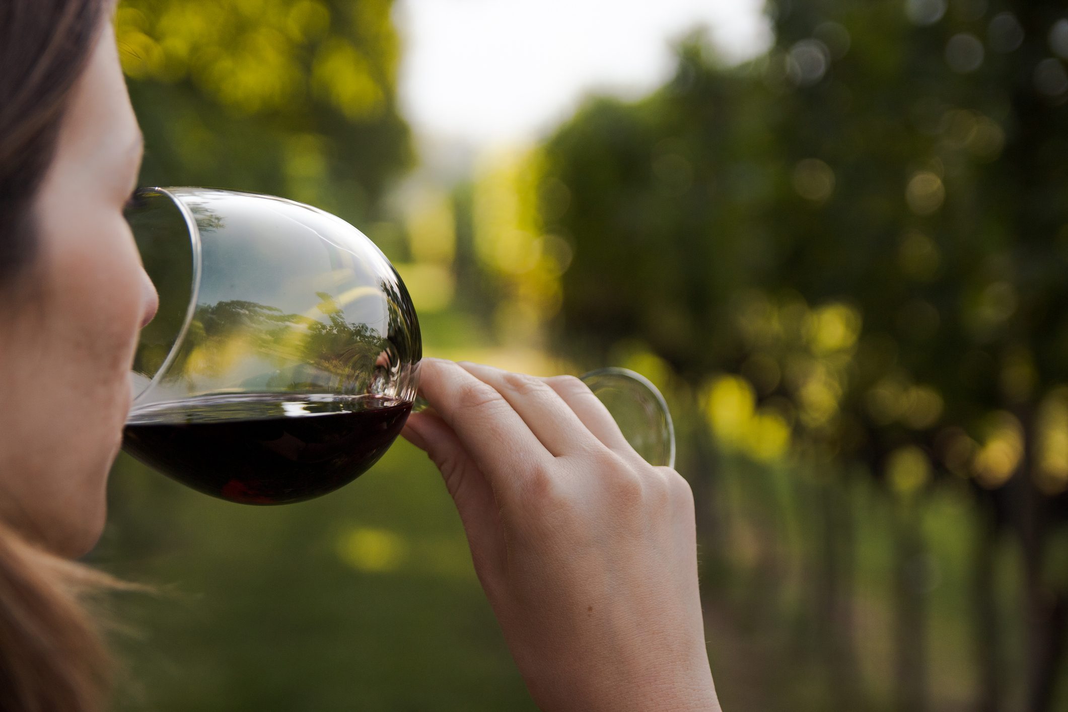 close up of young woman drinking red wine