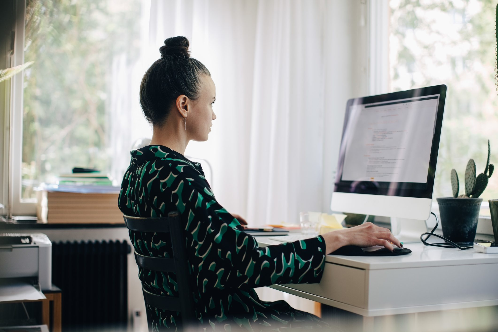 woman sitting at home desk