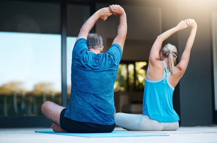 couple doing yoga outside