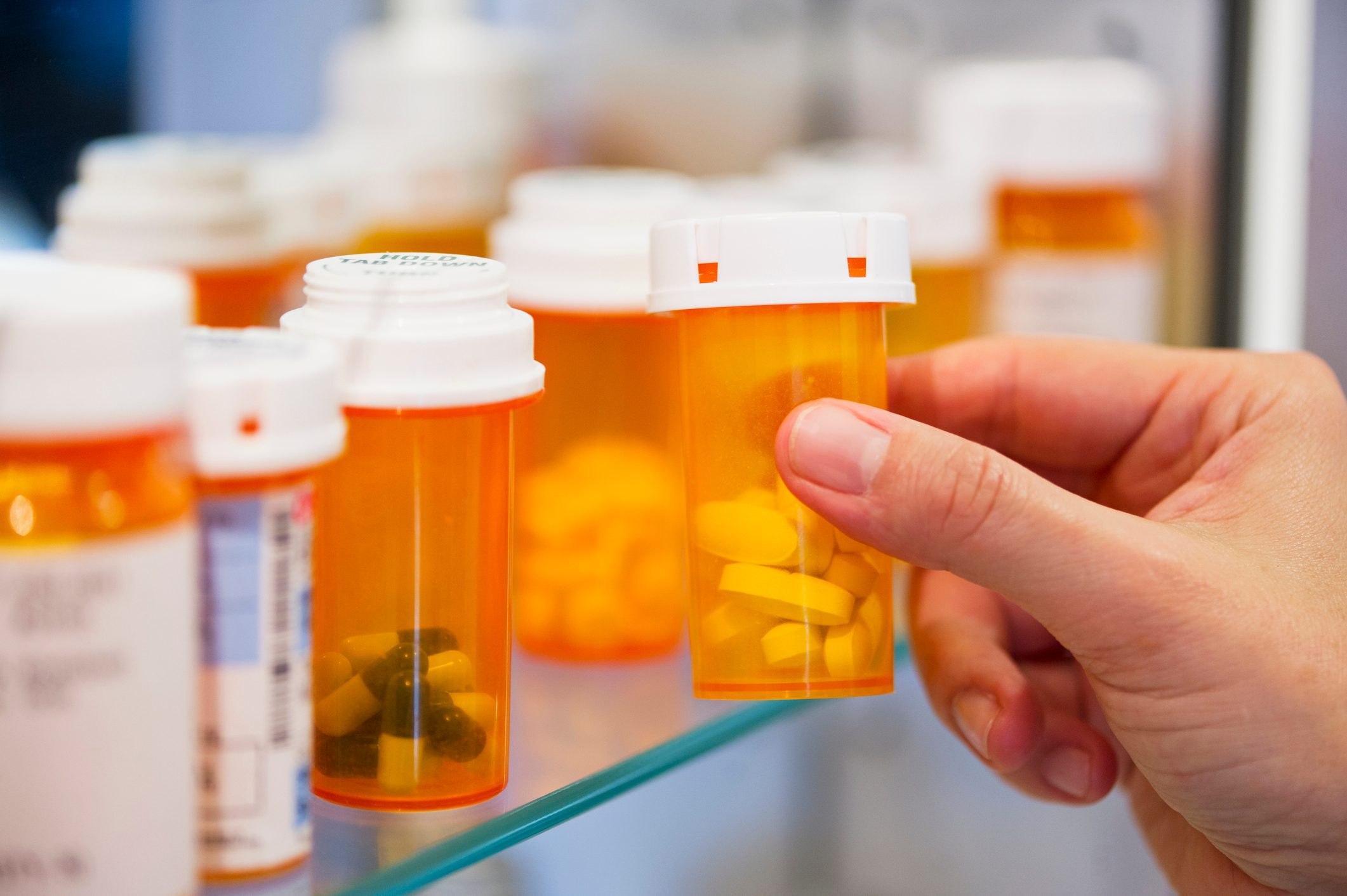 prescription pill bottles in medicine cabinet