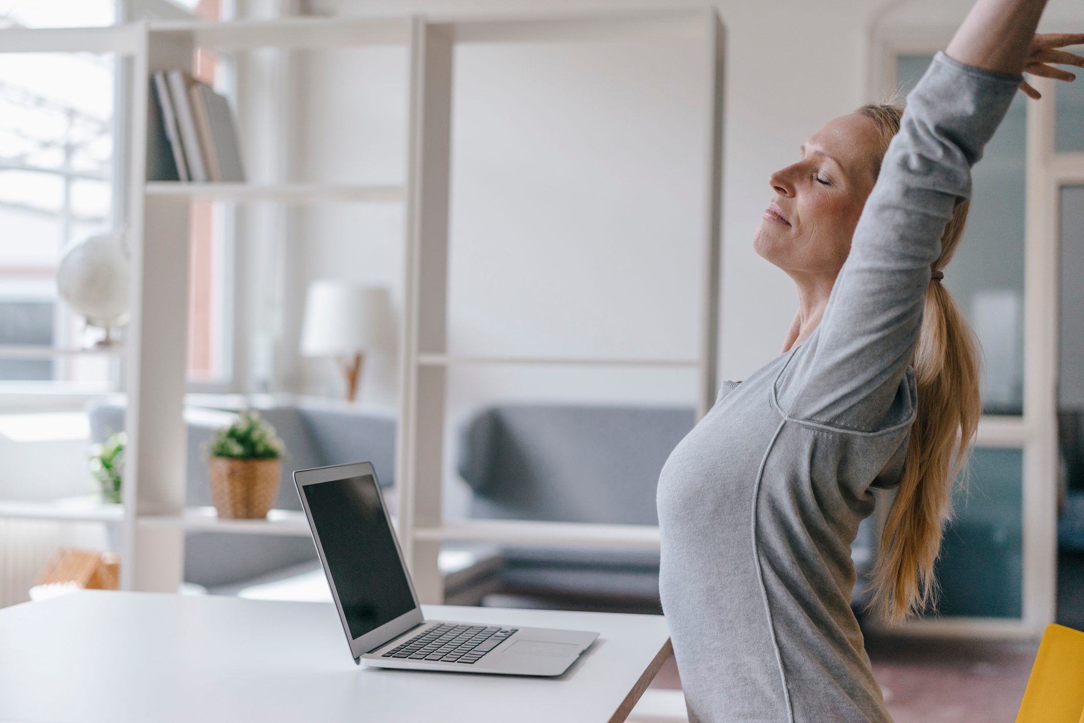 woman stretching at desk