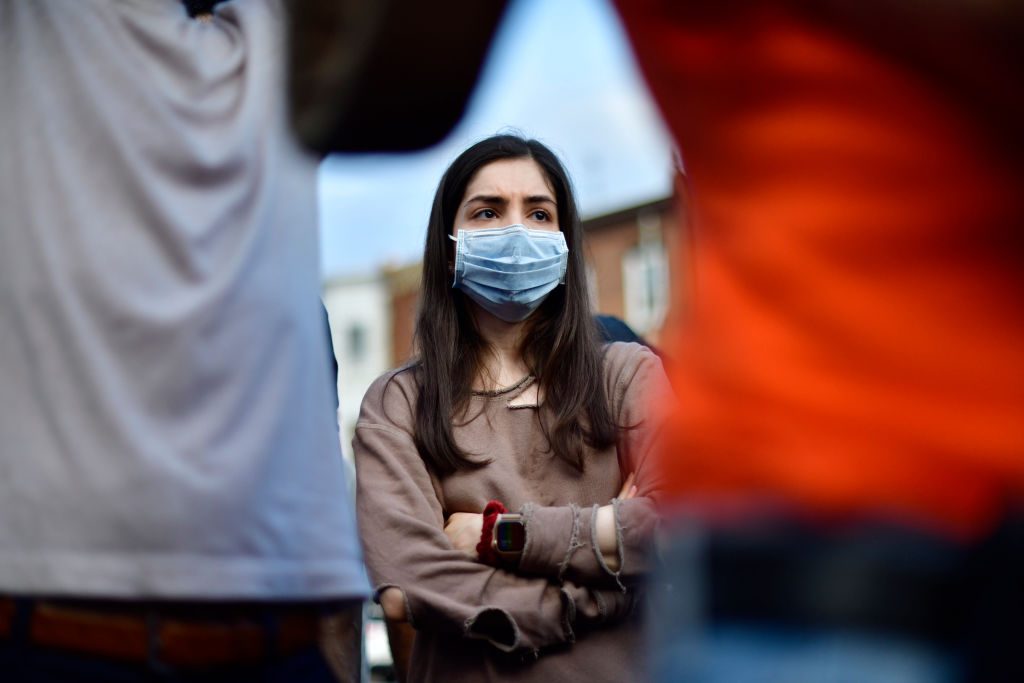 woman wearing a face mask at a protest