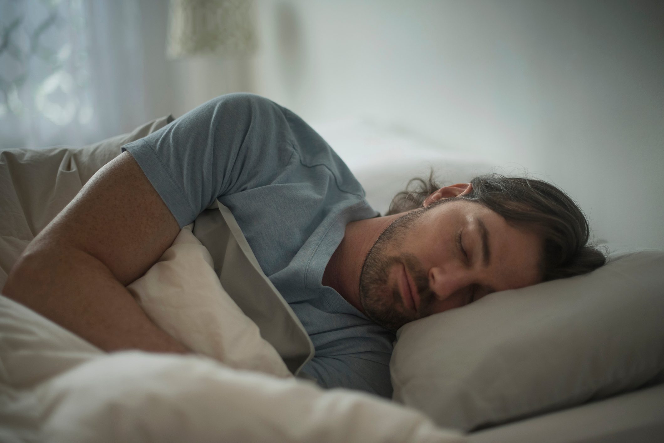 man laying asleep in bed