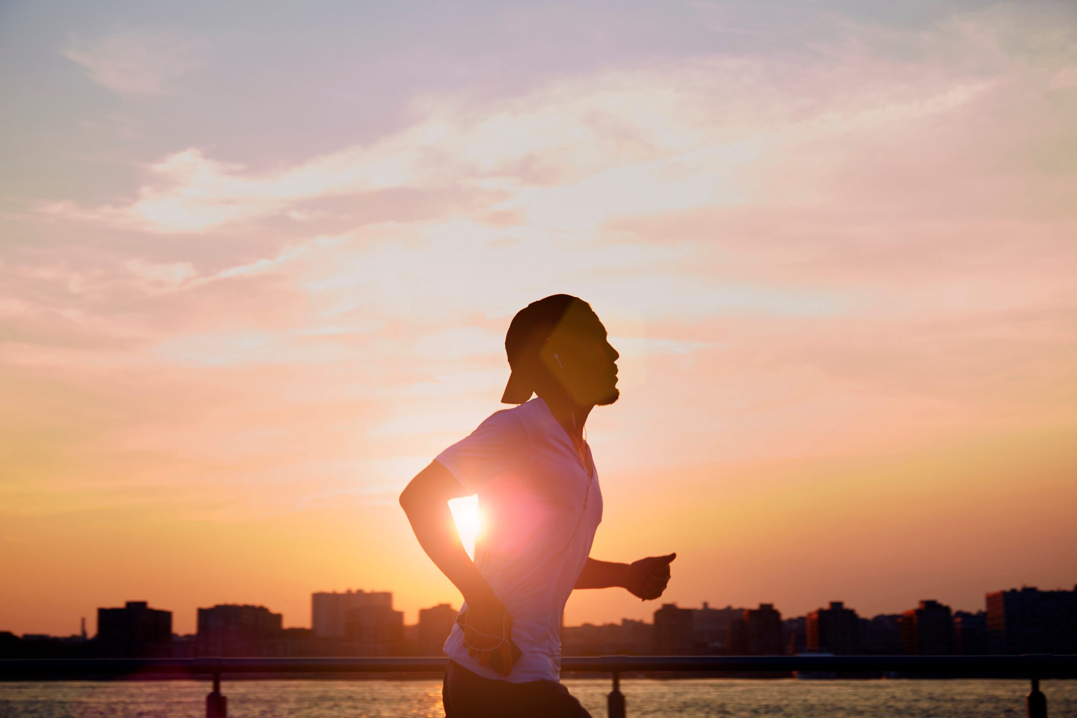 man enjoying an early morning jog during sunrise in the city